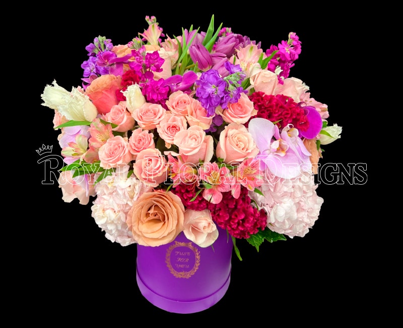 Lush roses, hydrangea and orchids in a purple keepsake box