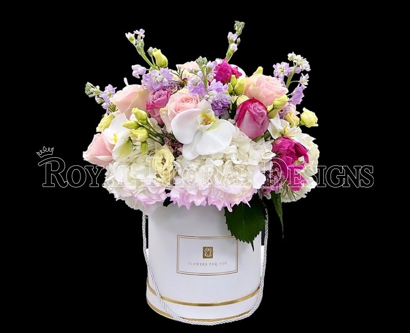 Elegant white and lavender arrangement in a gold-rimmed box