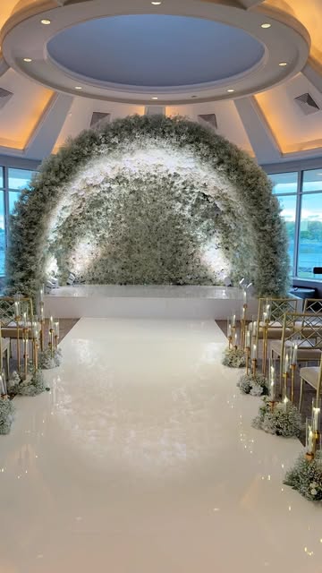 White floral aisle arch over a mirrored dance floor at a ballroom wedding