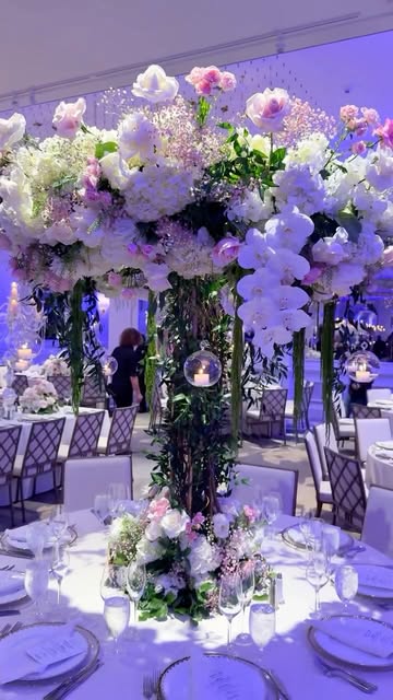 Tall orchid centerpiece on a styled dinner-party table